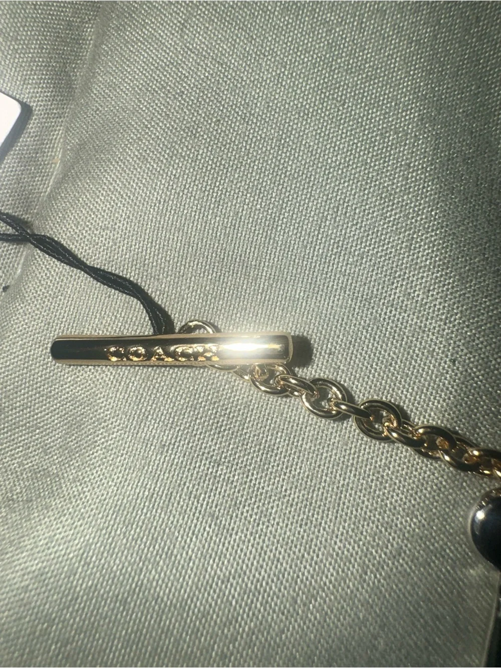 Coach Gold tone Charm Bracelet with Padlock, Key and Pearl Accents CD855 A31